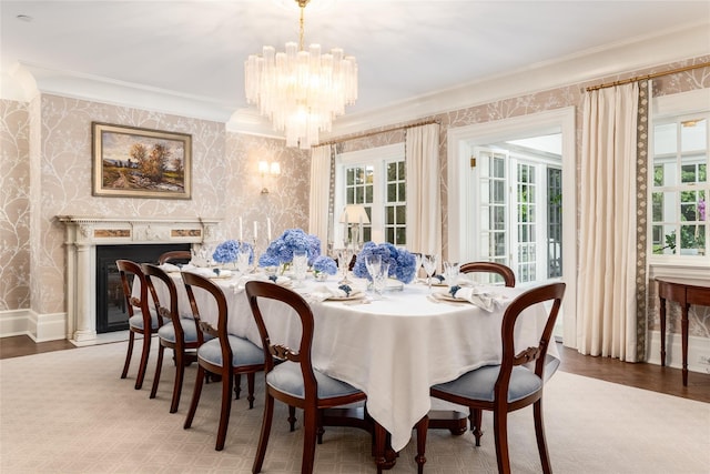 dining room with a fireplace, an inviting chandelier, and ornamental molding