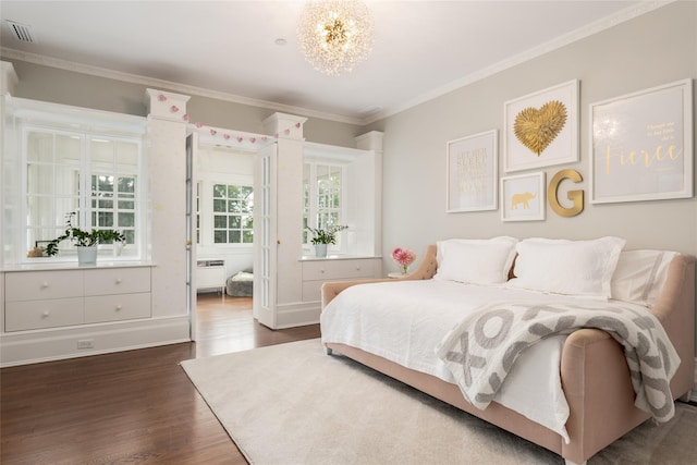 bedroom with a chandelier, ornamental molding, and dark hardwood / wood-style floors