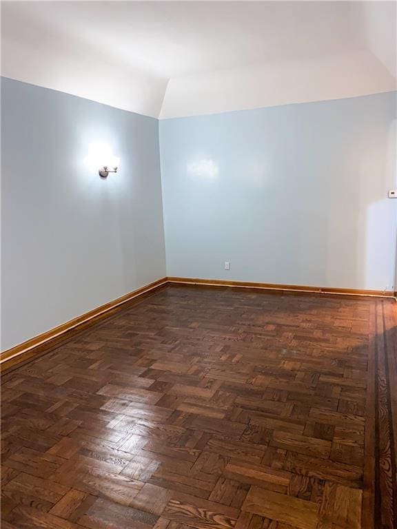 unfurnished room featuring dark parquet floors