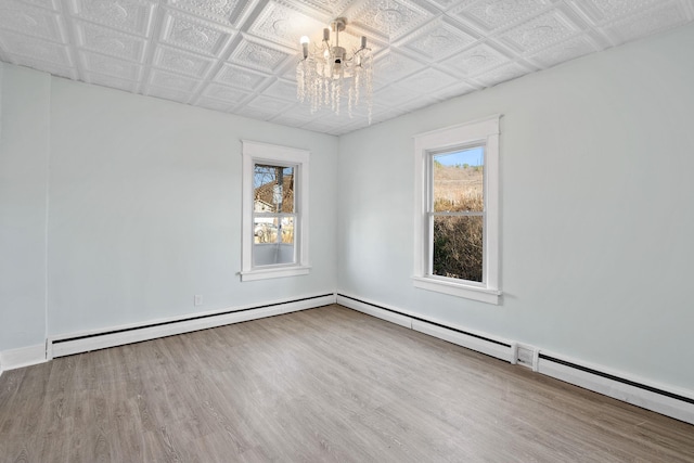 29 Thompson St, Port Jervis, NY 12771 - spare room featuring wood finished floors, an ornate ceiling, a chandelier, and a wealth of natural light