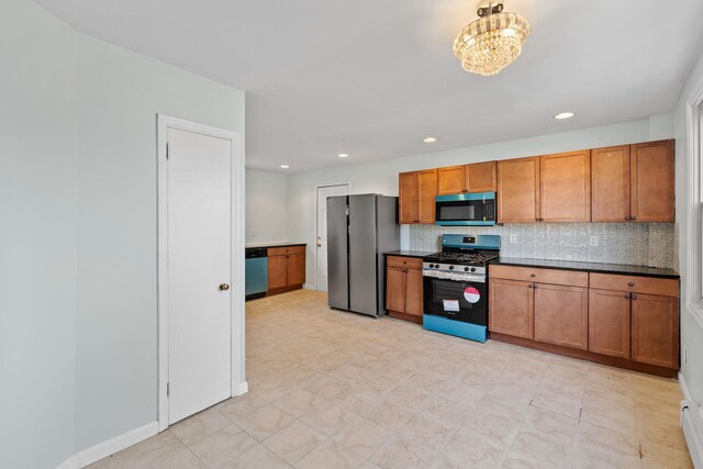 29 Thompson St, Port Jervis, NY 12771 - kitchen featuring brown cabinets, dark countertops, tasteful backsplash, and stainless steel appliances