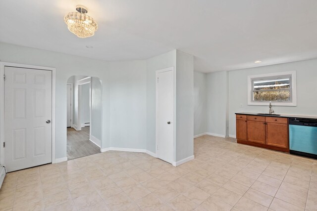29 Thompson St, Port Jervis, NY 12771 - empty room featuring a baseboard radiator, baseboards, arched walkways, a sink, and a notable chandelier