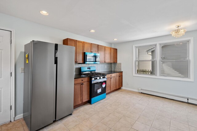 29 Thompson St, Port Jervis, NY 12771 - kitchen featuring tasteful backsplash, baseboard heating, brown cabinetry, stainless steel appliances, and dark countertops