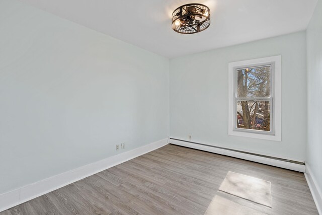 29 Thompson St, Port Jervis, NY 12771 - empty room with baseboards, wood finished floors, and a baseboard radiator