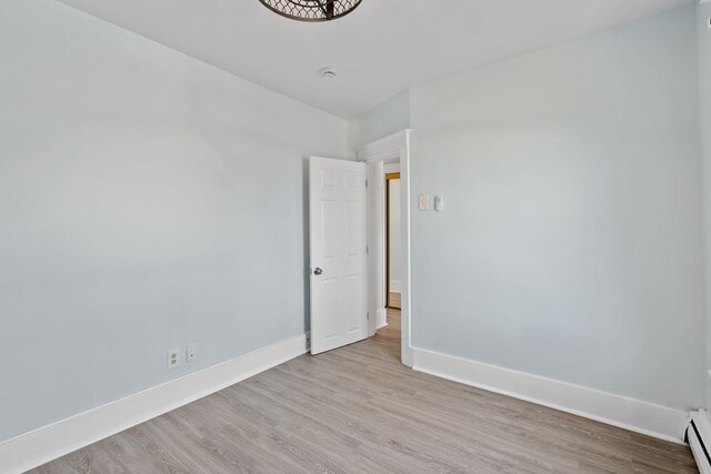 29 Thompson St, Port Jervis, NY 12771 - unfurnished room with light wood finished floors, baseboards, and baseboard heating