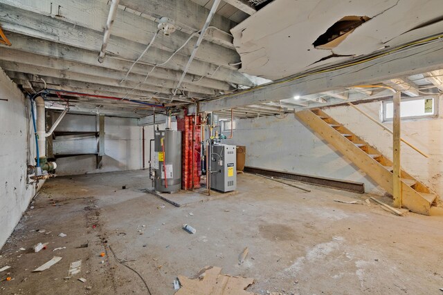 29 Thompson St, Port Jervis, NY 12771 - below grade area featuring heating unit, gas water heater, and stairs