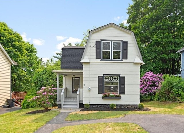 view of front of house with a front yard and a porch