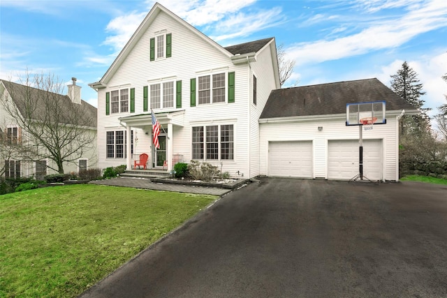 front of property featuring a front yard and a garage