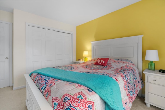 bedroom featuring a closet and light colored carpet