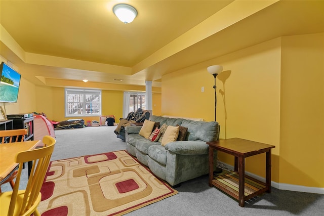 carpeted living room with a tray ceiling