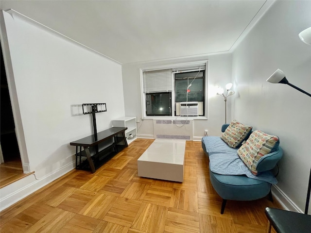 living room featuring light parquet flooring, radiator, and cooling unit