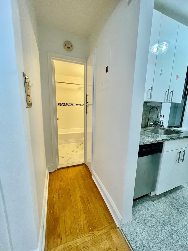 hall featuring light hardwood / wood-style floors and sink