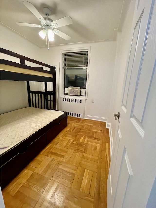 bedroom featuring radiator heating unit and light parquet floors