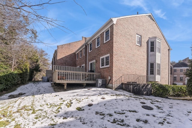 79 Marjorie Ct, Manhasset, NY 11030 - snow covered rear of property with a deck and brick siding