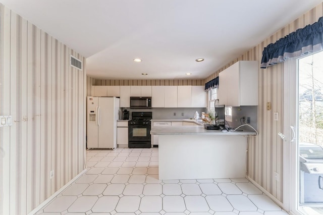 79 Marjorie Ct, Manhasset, NY 11030 - kitchen with black appliances, light floors, plenty of natural light, wallpapered walls, and recessed lighting