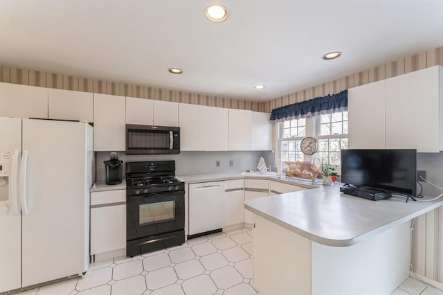79 Marjorie Ct, Manhasset, NY 11030 - kitchen with white appliances, a peninsula, light countertops, recessed lighting, and light flooring
