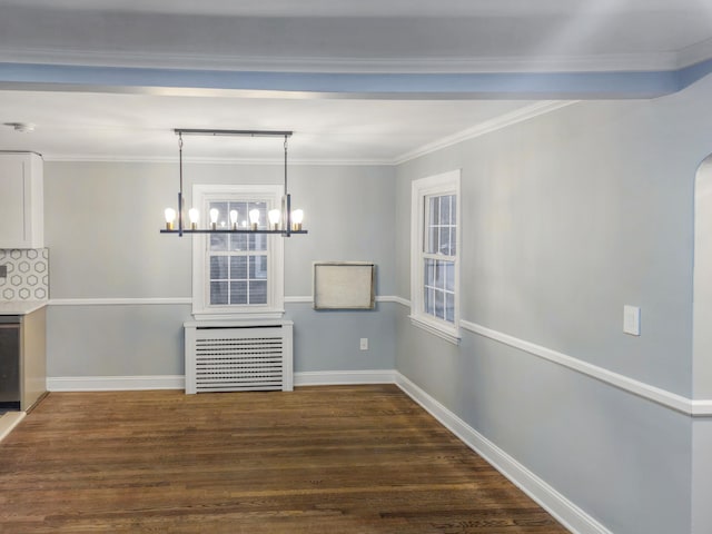 unfurnished dining area with dark wood-type flooring, crown molding, and a chandelier