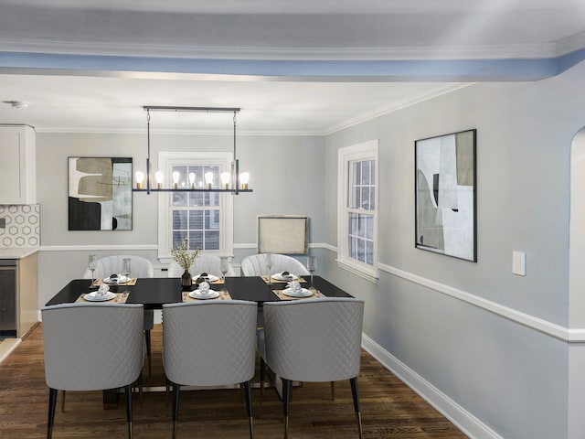 dining area featuring dark wood-type flooring, crown molding, and an inviting chandelier