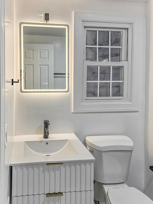 bathroom featuring vanity and toilet