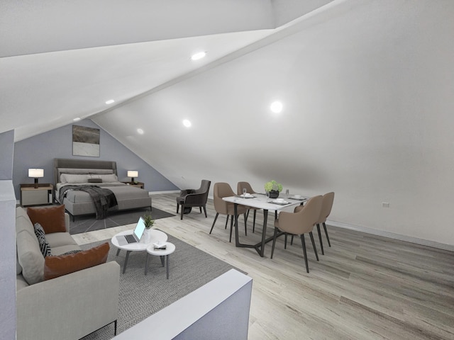 bedroom featuring light wood-type flooring and vaulted ceiling