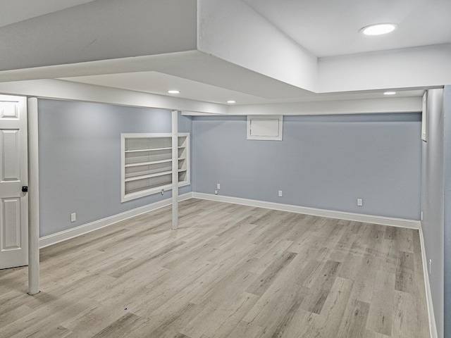 basement featuring light hardwood / wood-style floors and built in features