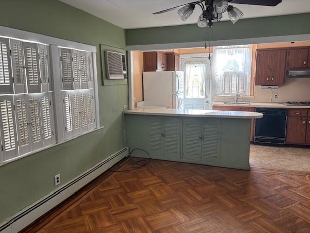 kitchen with ceiling fan, a baseboard heating unit, white refrigerator, black dishwasher, and range hood