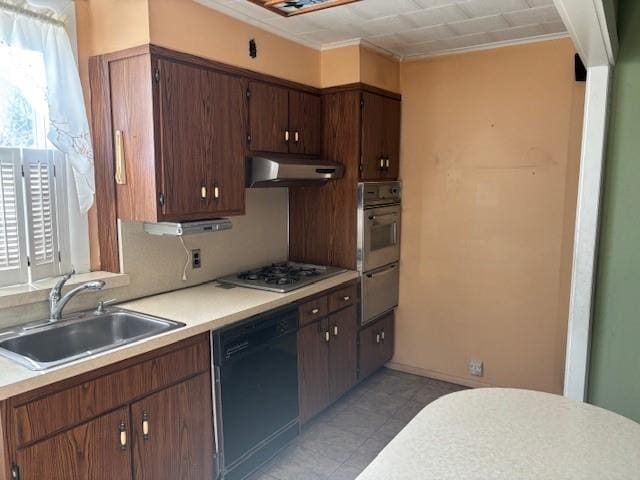 kitchen with appliances with stainless steel finishes, dark brown cabinetry, crown molding, and sink