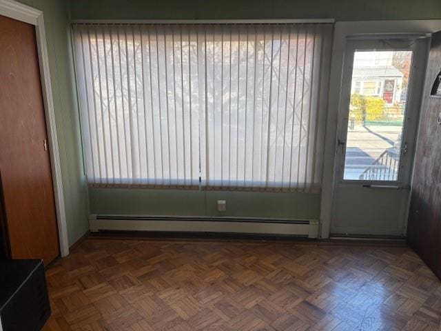 doorway featuring dark parquet floors and baseboard heating