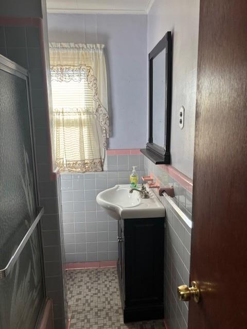 bathroom with vanity and tile walls