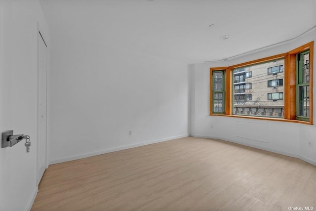 spare room with light hardwood / wood-style floors