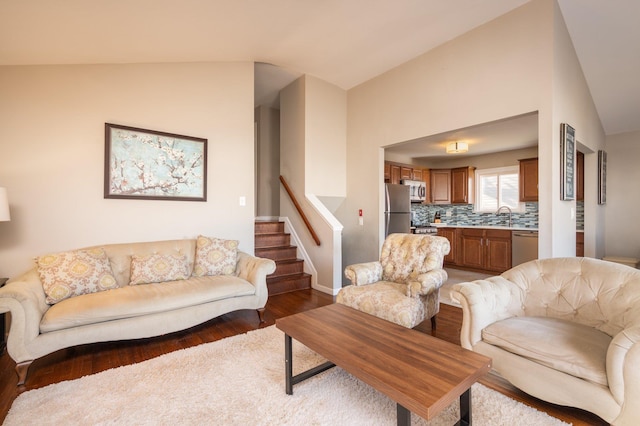 living room featuring sink, dark hardwood / wood-style flooring, and vaulted ceiling