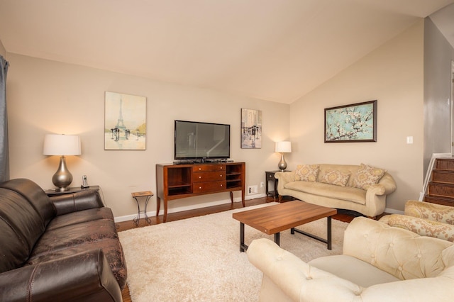 living room featuring hardwood / wood-style flooring and lofted ceiling