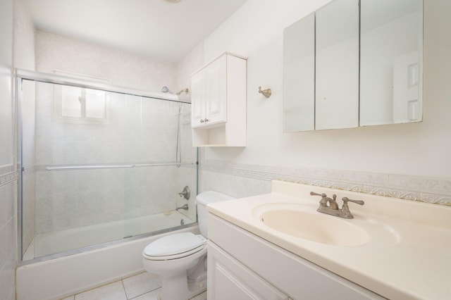 full bathroom featuring enclosed tub / shower combo, tile patterned flooring, vanity, tile walls, and toilet