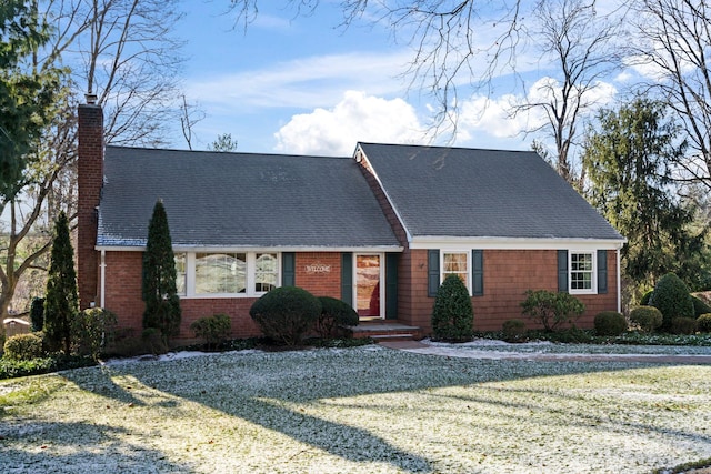 cape cod home with a front yard