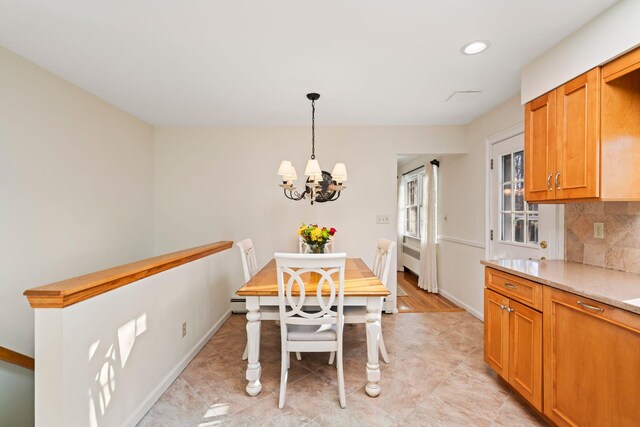 dining space featuring an inviting chandelier