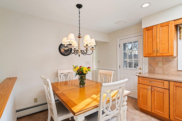 tiled dining space featuring an inviting chandelier and baseboard heating