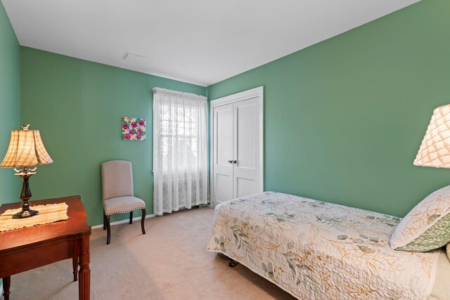 carpeted bedroom featuring a closet