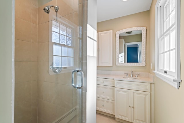 bathroom featuring an enclosed shower and vanity