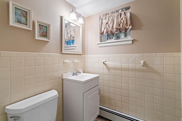 bathroom featuring tile walls, toilet, vanity, and a baseboard heating unit