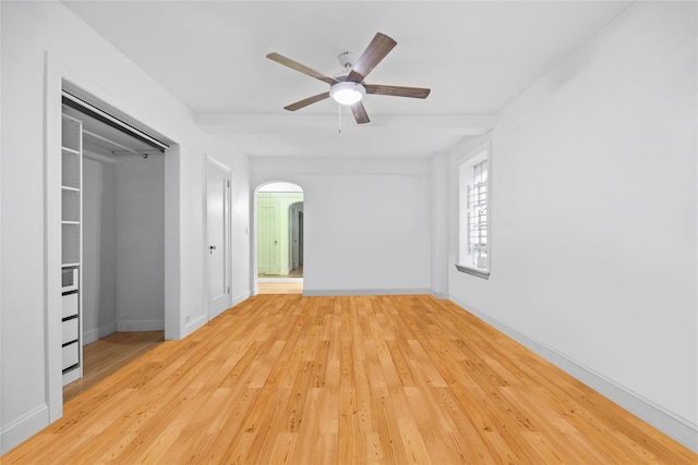 unfurnished bedroom with ceiling fan, a closet, and light hardwood / wood-style floors