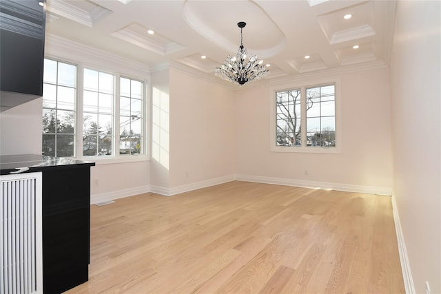 interior space with plenty of natural light, coffered ceiling, beam ceiling, and light hardwood / wood-style floors