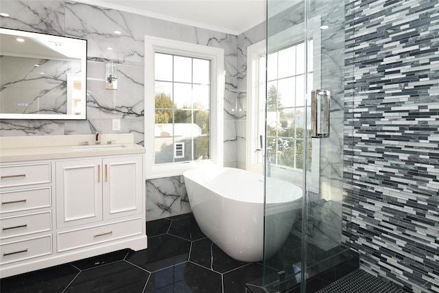 bathroom featuring crown molding, tile walls, vanity, plus walk in shower, and tile patterned flooring