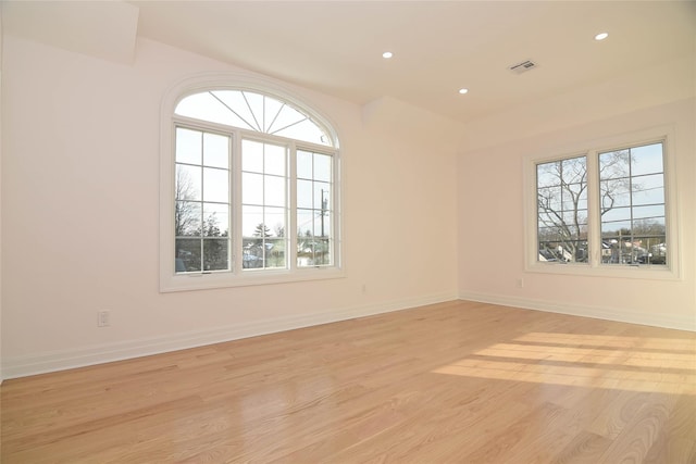 empty room with light hardwood / wood-style flooring