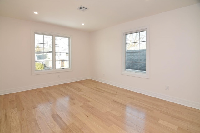 unfurnished room with light wood-type flooring