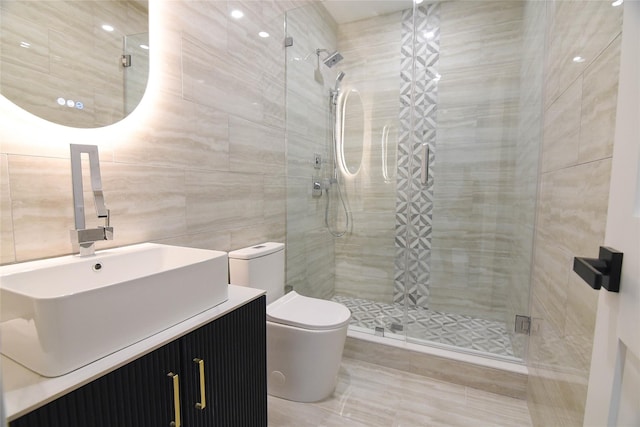 bathroom with vanity, tile walls, an enclosed shower, and toilet