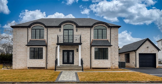 french provincial home featuring a garage, an outdoor structure, a front lawn, and central air condition unit