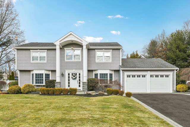 view of front of property with a garage and a front yard