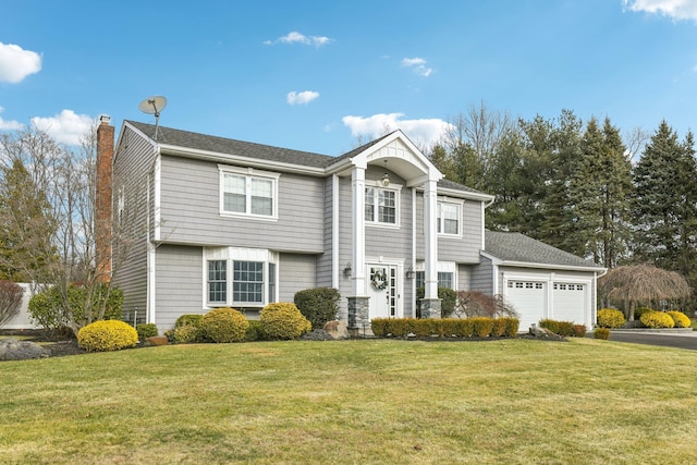 front facade with a front lawn and a garage