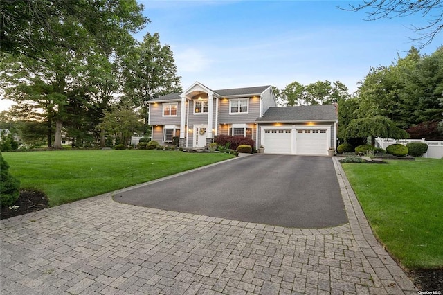 view of front of property with a front yard and a garage