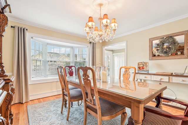 dining area with light hardwood / wood-style floors, baseboard heating, crown molding, and an inviting chandelier